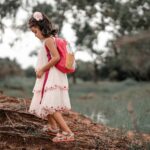 child exploring rocks nature